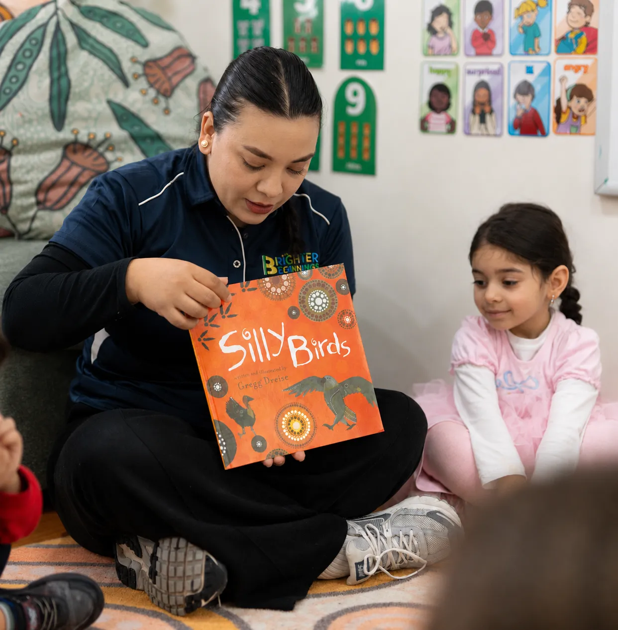 An educator sitting with a child during a visit
